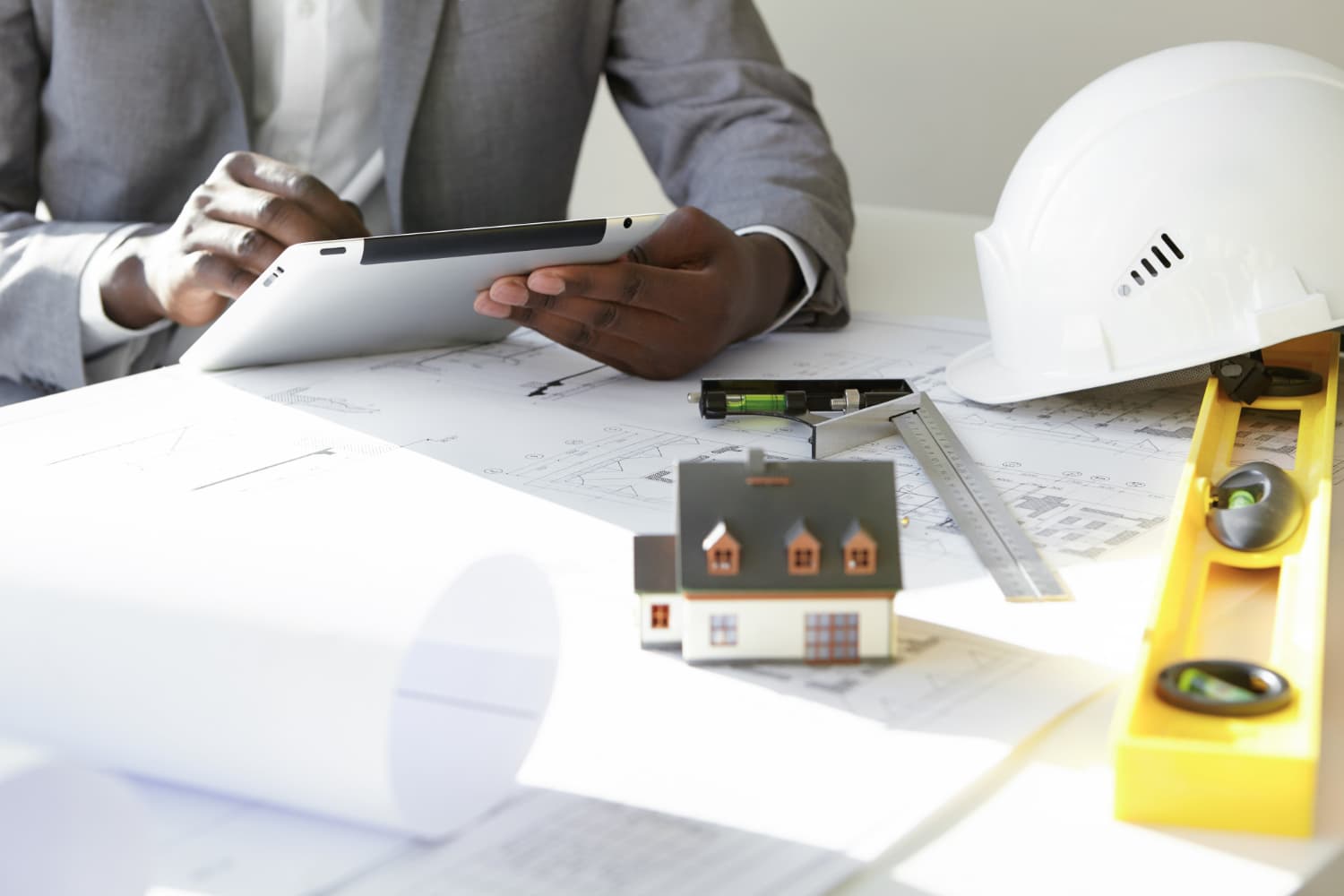 Construction project manager inspecting site progress and reviewing project plans – De Finibus Construction Limited Lagos.