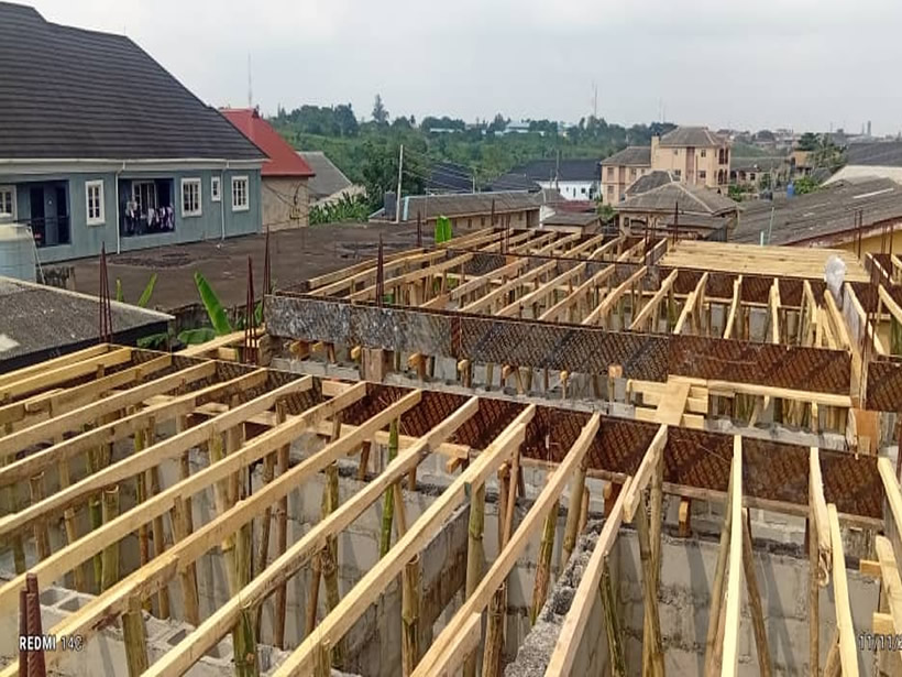 Structural engineer analyzing load calculations and structural drawings for a building project – De Finibus Construction Limited Nigeria.